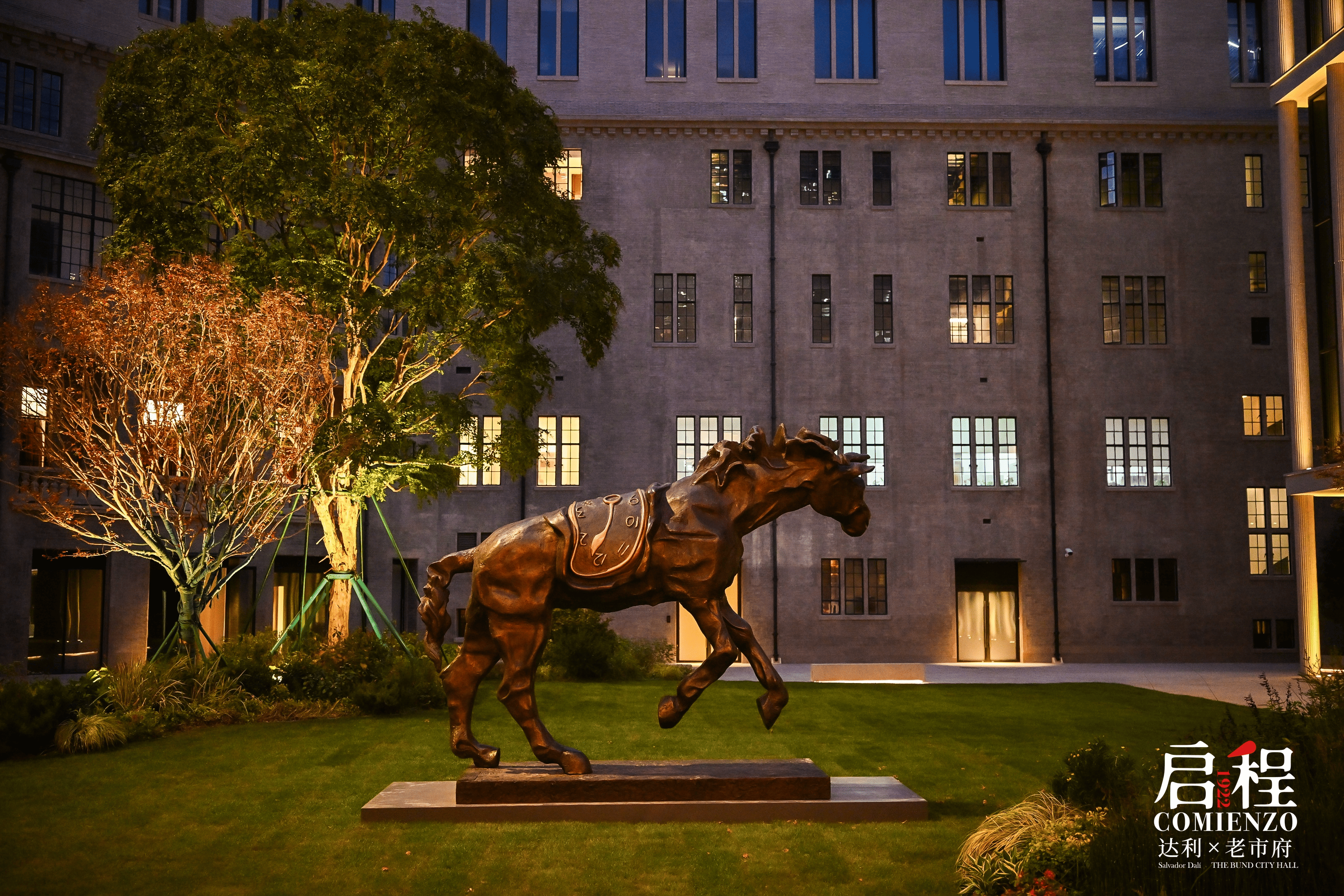 High-resolution panoramic project photo showing the Dalí exhibition setting at dusk with the outdoor horse sculpture in view